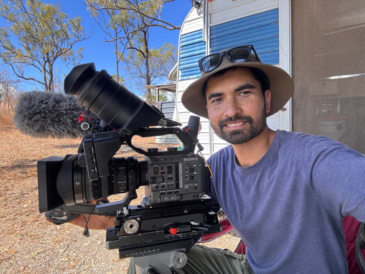John W. Sullivan on location with a camera